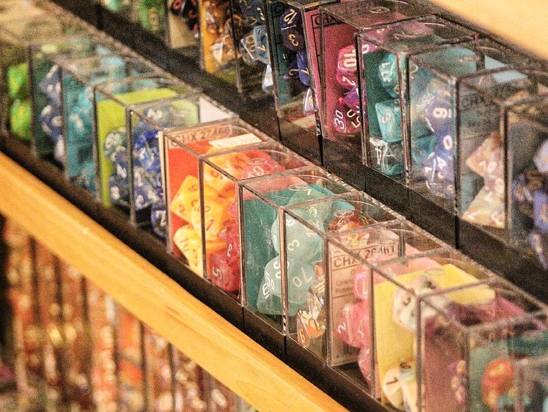 Two rows of many different types of dice.